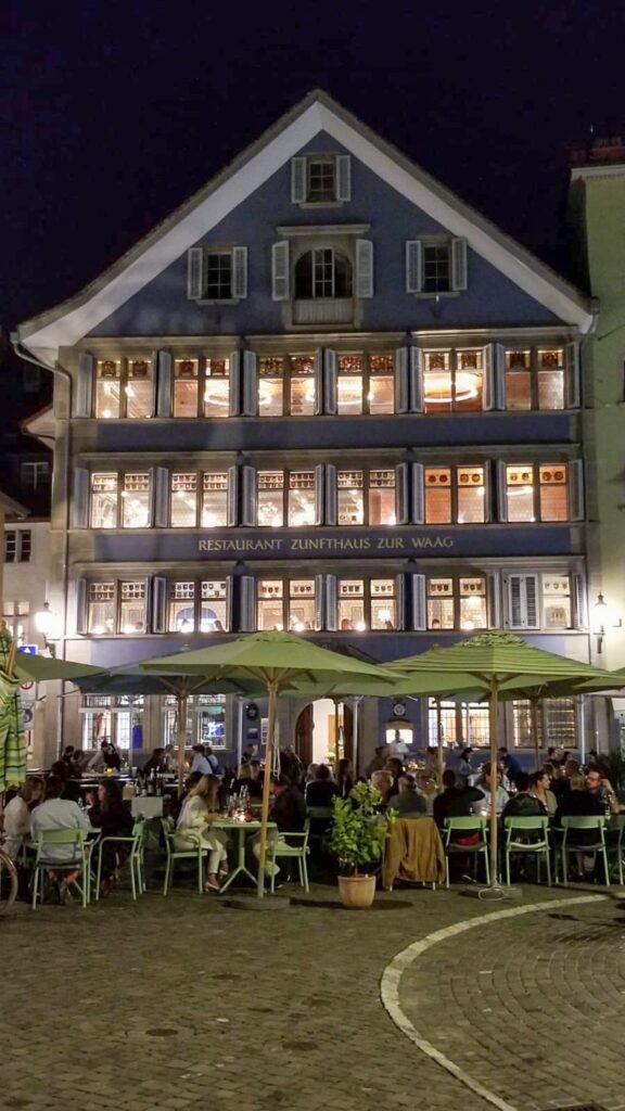 outside of Restaurant Zunfthaus zur Waag at night in Zurich Switzerland