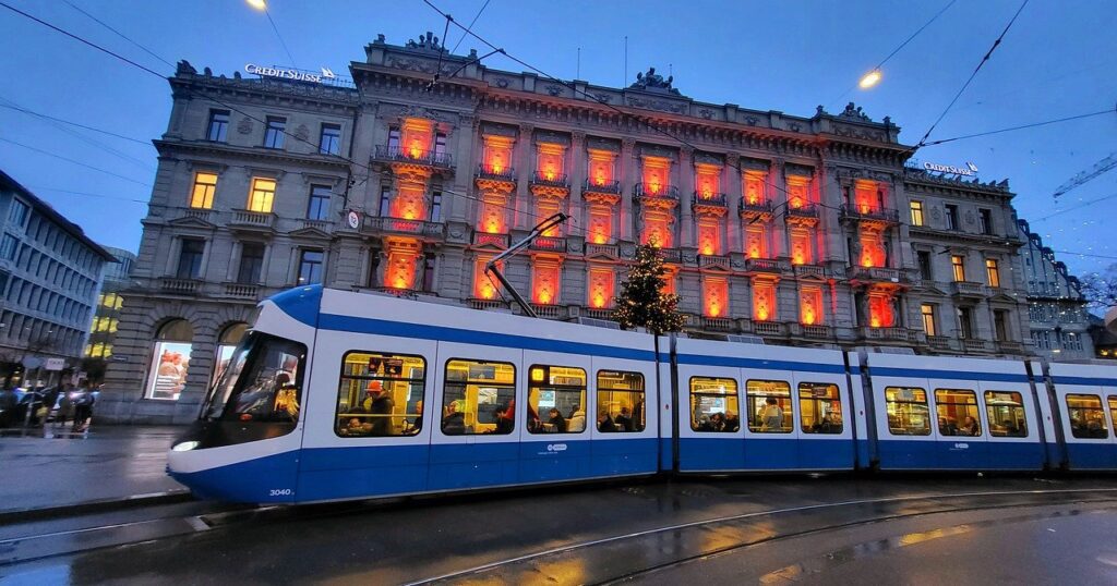 blue and white tram at dusk in zurich switzerland